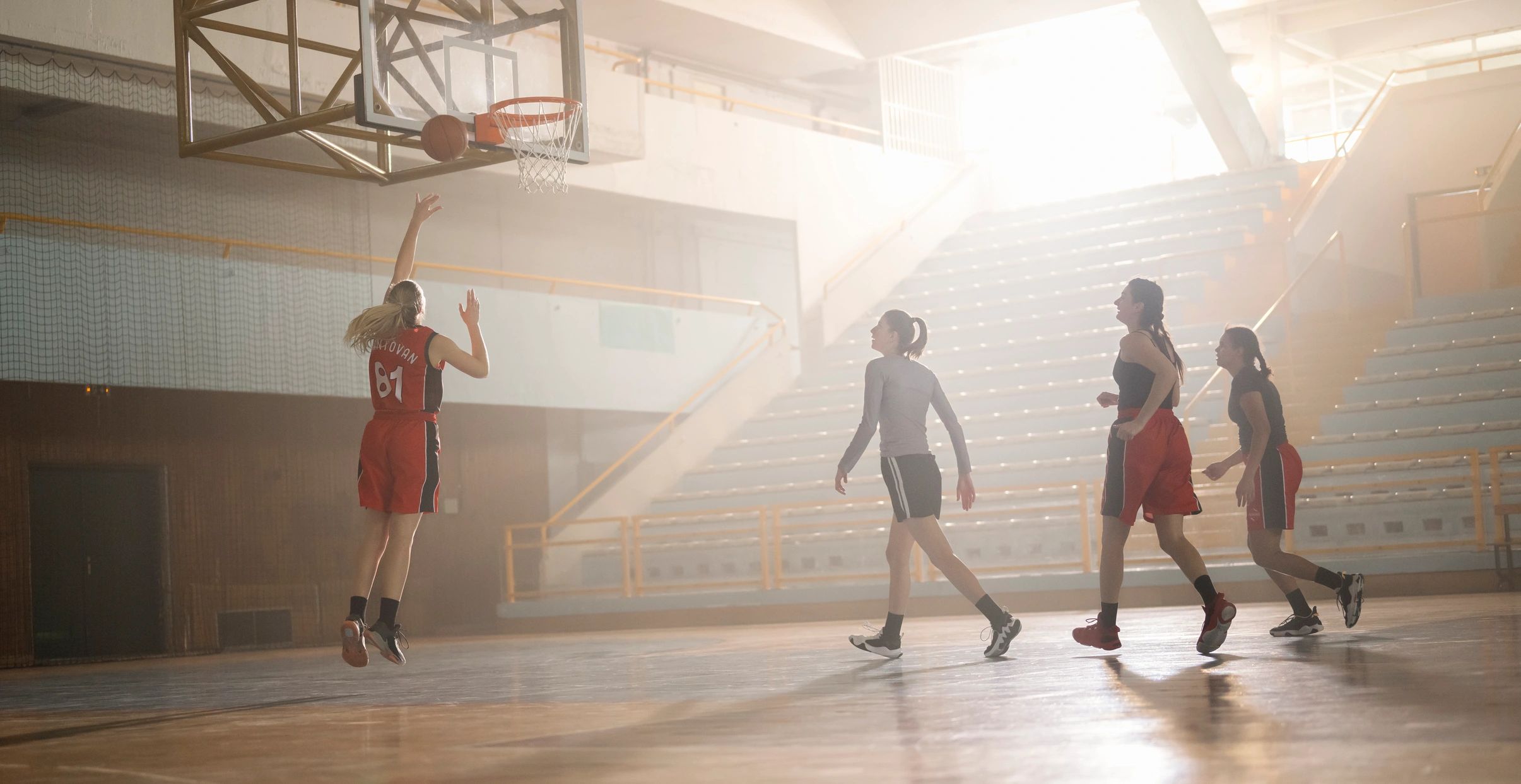 College basketball team practicing together on court